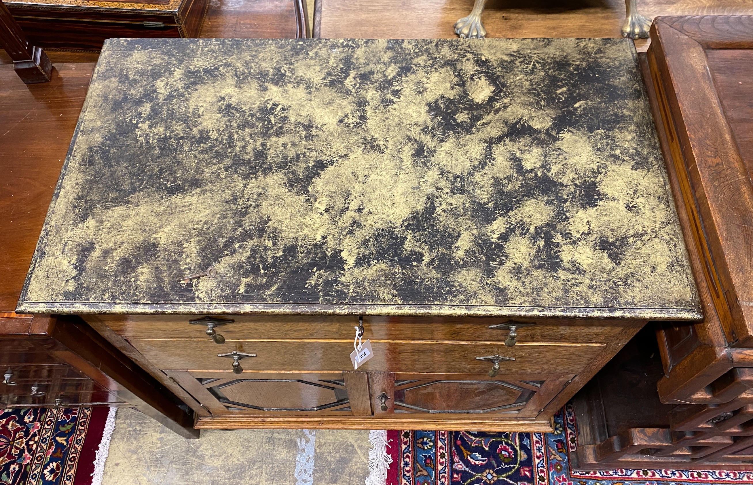 A 1920's oak side cabinet with painted faux marble top, width 83cm, depth 46cm, height 86cm